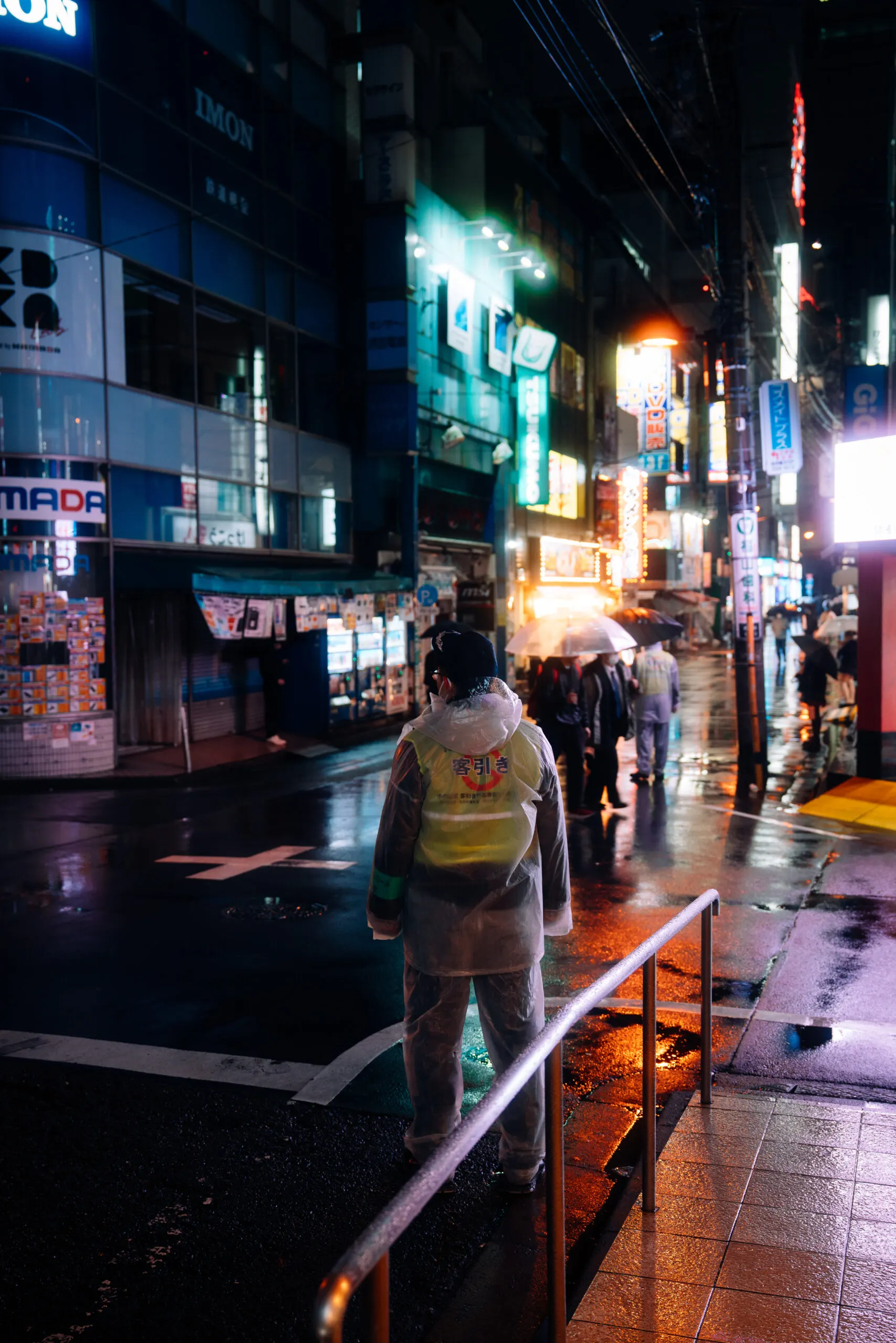Neon side street with pedestrians at night